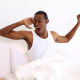 Smiling Man Yawning And Stretching Sitting In Bed - VideoHive Item for Sale