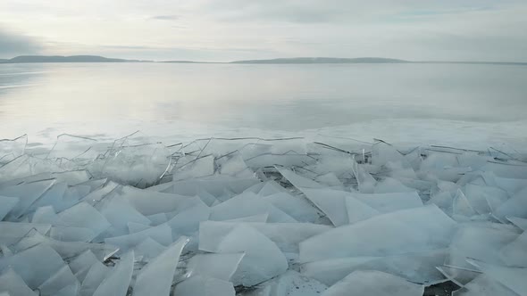 The Northern Landscape of a Frozen Lake or River. Shards of Ice Near the Shore, in the Distance