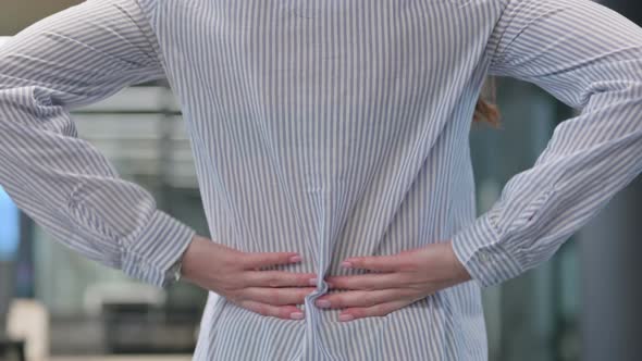 Close up of Woman Holding Back while having Pain