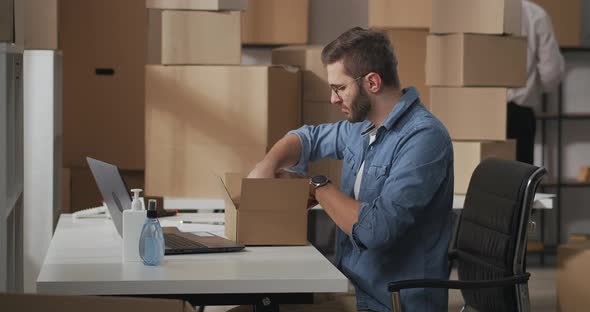 Small Business Owner Sits at a Table in the Office