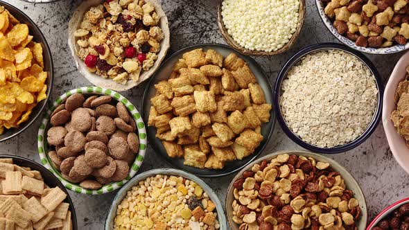 Assortment of Different Kinds Cereals Placed in Ceramic Bowls on Table