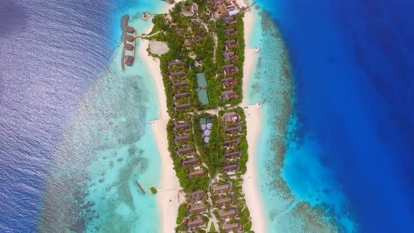 Aerial view of bungalow resort in the middle of forest, Maldives island.
