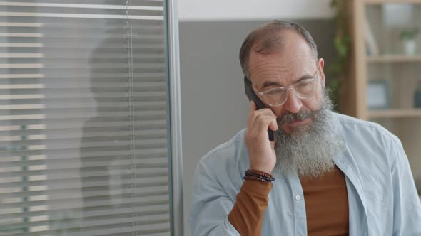 Man Talking on Phone in Office