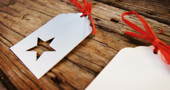 Close-up christmas tag kept in row on wooden plank 4k