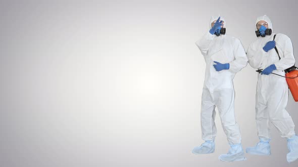 Anti Coronavirus Disinfection Team of Virologists in Hazmat Suits Making Plan of Disinfection on