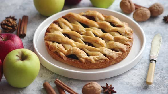 Tasty Sweet Homemade Apple Pie Cake with Cinnamon Sticks, Walnuts and Apples