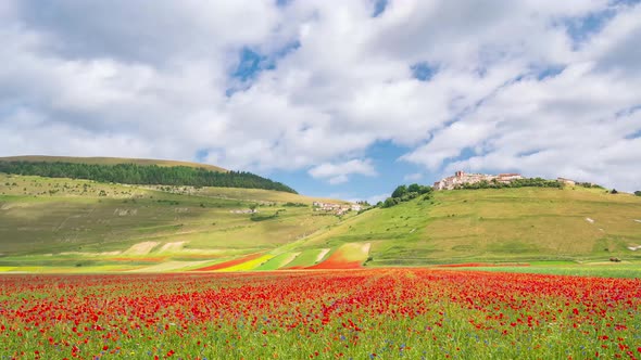 Time lapse: clouds moving over Castelluccio di Norcia highlands, Italy. The village perched on hill