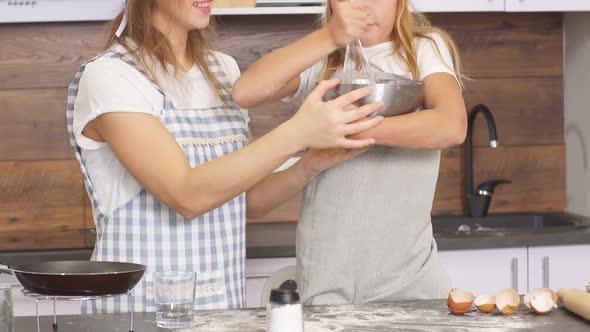 Funny Mother and Daughter Making Dough for Baking