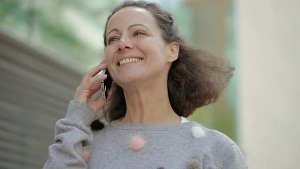 Happy Middle Aged Woman Talking on Phone.