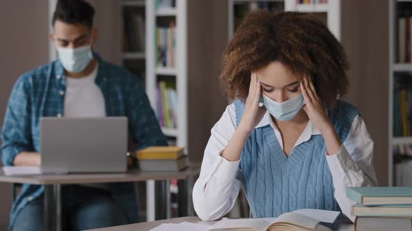 Students Study in Library Young Focused Woman in Medical Mask Sitting at Desk Tired Girl Reading