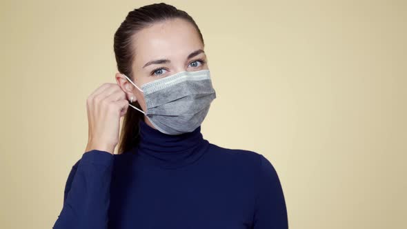 Portrait of Woman Takes Off Protective Medical Mask, Breathes Deeply and Smiles