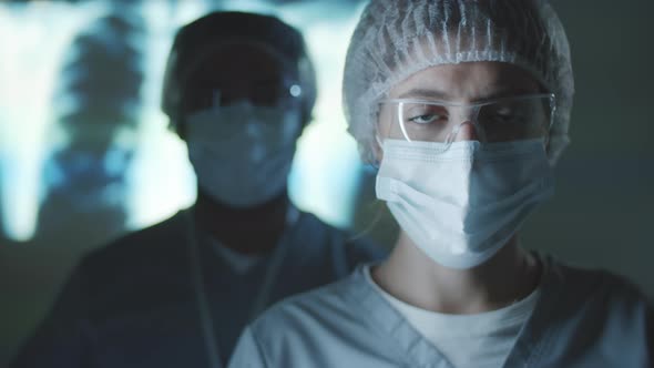 Portrait of Healthcare Workers in Protective Uniform in Dark Lab