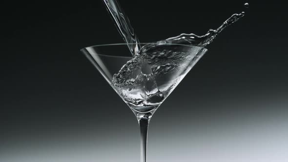 Pouring water into martini glass, Slow Motion