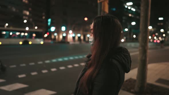 Female Model Wearing Mask Against Virus Walking Alone in the Night City