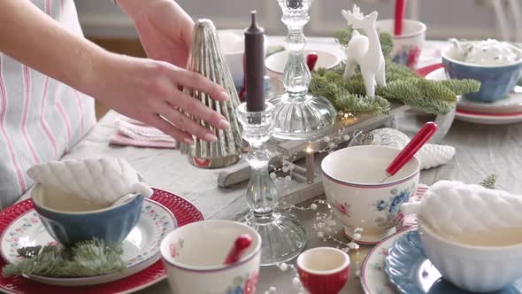 Christmas Table Decoration. Festive Table Setting. Female Hands Decorate the Table for Christmas