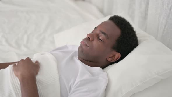 Peaceful African Man Sleeping in Bed 