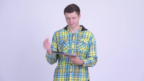 Stressed Young Man Getting Bad News with Digital Tablet