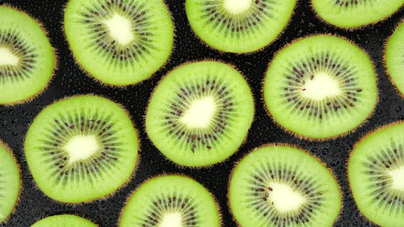 Sliced Kiwi fruit top view, rotation. 4K UHD video