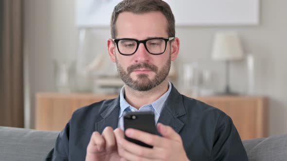 Portrait of Attractive Young Businessman Using Smartphone