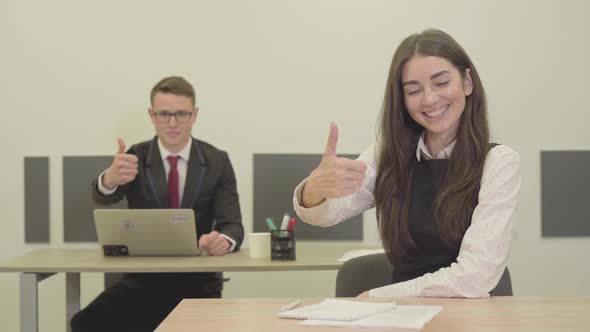 Portrait Confident Young Male and Female Manager in the Formal Wear Sitting at the Desks