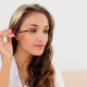 Young Woman Putting On Mascara And Looking In Hand - VideoHive Item for Sale