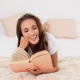 Young Woman Reading A Book Lying On Her Bed - VideoHive Item for Sale