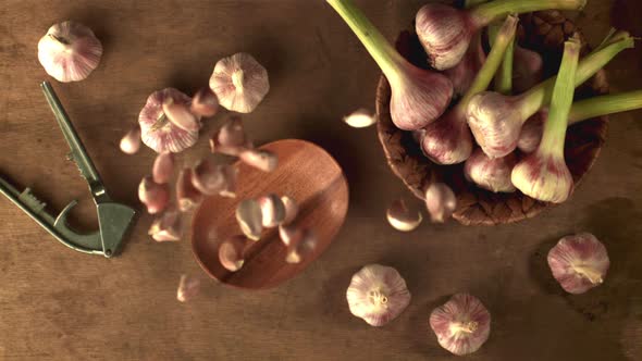 Super Slow Motion Garlic Falls on a Gray Table