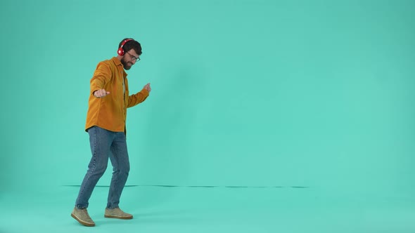 Bearded Man Wearing Headphones Dancing to Music