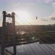 A Man Walks on a Rope Stretched Between the Supports of the Bridge at High Altitude - VideoHive Item for Sale