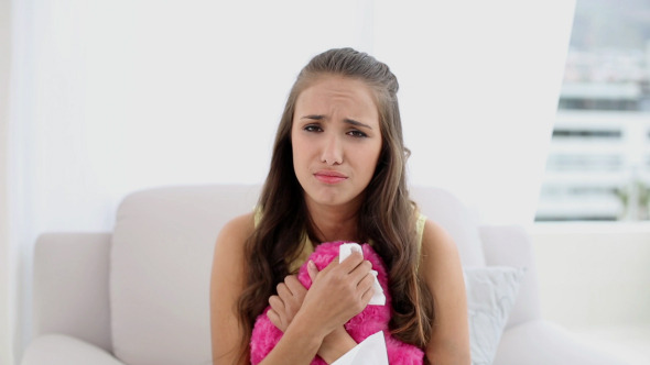 Young Woman Crying Over A Broken Heart On Sofa