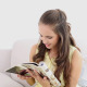 Young Woman Smiling And Reading A Magazine - VideoHive Item for Sale