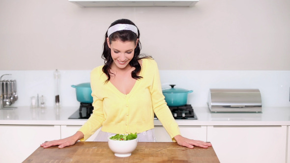 Beautiful Brunette Picking Up A Bowl Of Salad