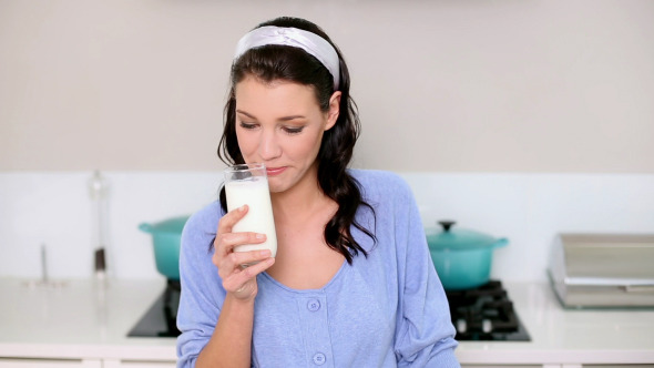 Beautiful Brunette Holding Two Salt Cellars