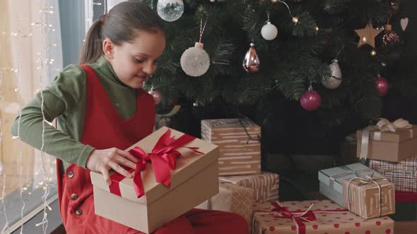 Girl Unpacking Christmas Present Box