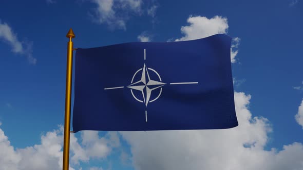 North Atlantic Treaty Organization flag waving with flagpole and blue sky