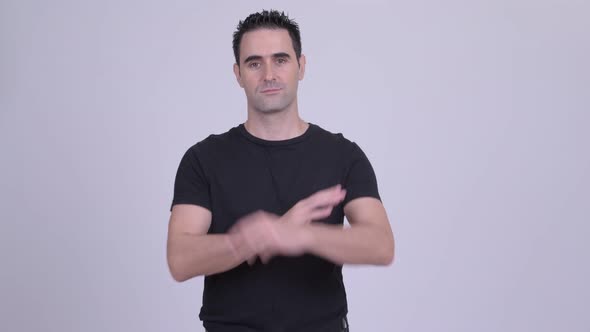 Handsome Man with Arms Crossed Against White Background