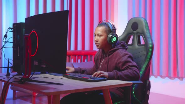 Male Child Biting Tooth During Video Game.Portrait Of Child Focusing On Computer Game