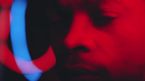Close Up of Face of Handsome Black Man in Blinking Neon Lights