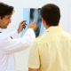 Doctor Looking At Xray With Patient And Smiling - VideoHive Item for Sale