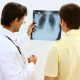 Smiling Doctor Looking At Xray With Patient - VideoHive Item for Sale