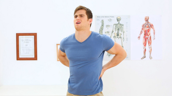 Patient Stretching His Back In Physiotherapy