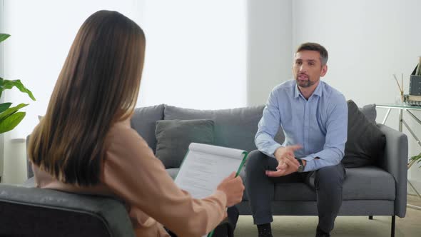 Emotional Adult Man Patient with Mental Health Problems Talking to Therapist