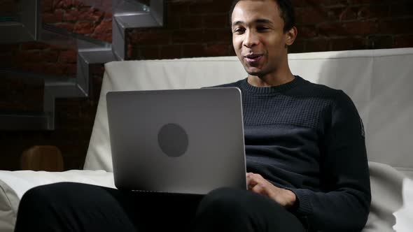 Web Video Chat on Laptop By Man Sitting on Stairs
