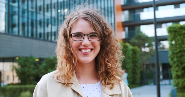 Portrait of girl smiling and winking to camera. Cheerful happy people. Young successful woman