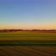 Aerial Cinematic Clip Drone Flying Over a Farm Field During Sunset - VideoHive Item for Sale