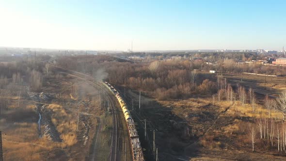 Aerial View of Train Moving Along Railway and Shipping Industrial Goods