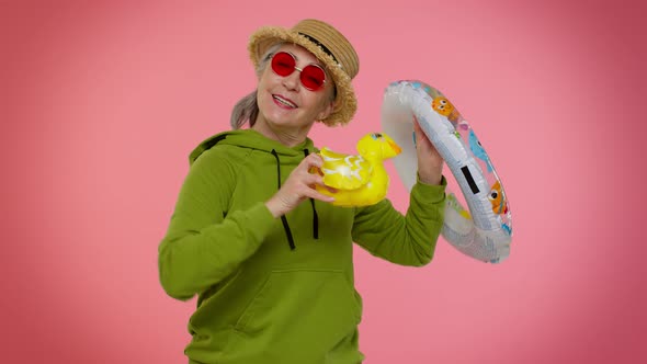 Senior Grandmother Traveler Tourist with Swimming Ring Ready for Vacation Journey Trip to Seaside