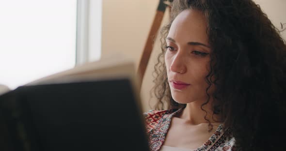 Beautiful mixed race woman reading book