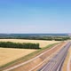 Aerial photography of agricultural fields in Russia. Beautiful views. Highway along the fields. - VideoHive Item for Sale