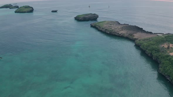 Fishing boats in Watamu Bay Beach at sunrise near Malindi, Kenya. Aerial drone reveal